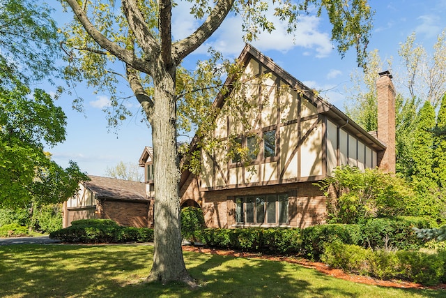 rear view of property with a lawn