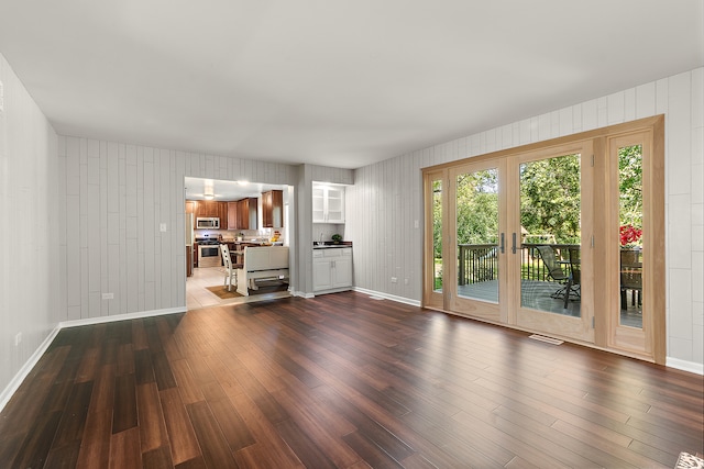 unfurnished living room with french doors and hardwood / wood-style flooring