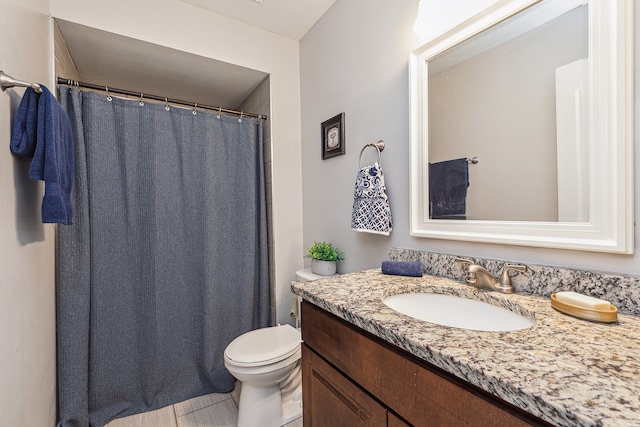 bathroom featuring vanity, toilet, and tile patterned floors