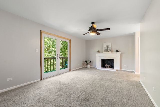 unfurnished living room with carpet flooring, ceiling fan, and a brick fireplace