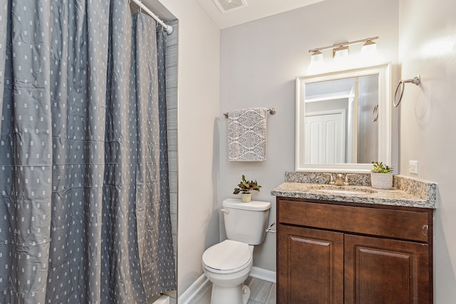 bathroom featuring vanity, toilet, and a shower with shower curtain