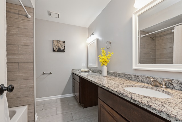 bathroom with shower / bath combo with shower curtain and vanity