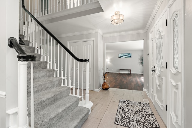 foyer entrance featuring light hardwood / wood-style flooring and crown molding