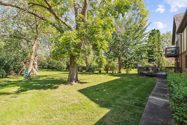 view of yard with a playground and a wooden deck