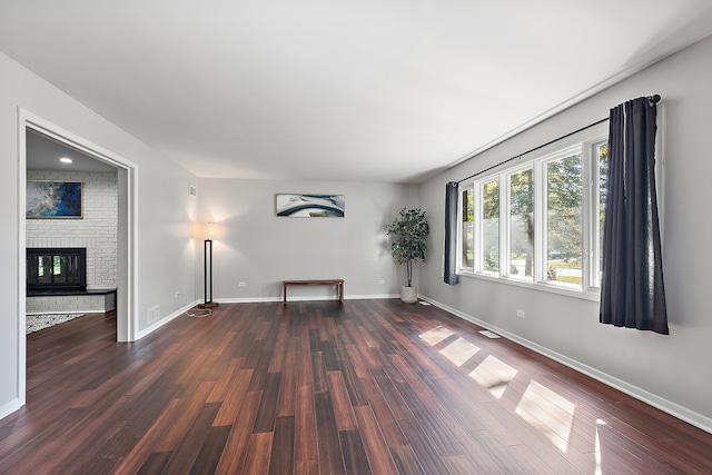 interior space with a fireplace and dark hardwood / wood-style flooring