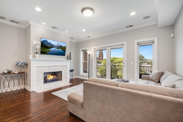 living room with a fireplace with flush hearth, dark wood-style flooring, visible vents, and baseboards