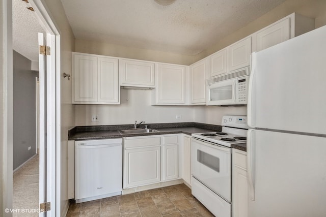 kitchen featuring sink, light tile patterned flooring, white cabinetry, and white appliances