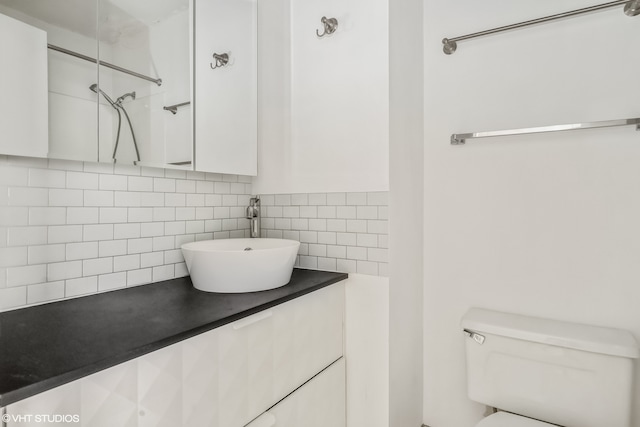 bathroom featuring vanity, toilet, tasteful backsplash, and tile walls