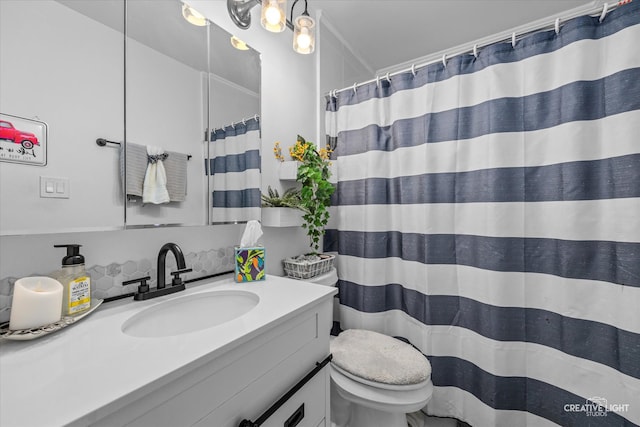 bathroom featuring vanity, toilet, and a shower with shower curtain