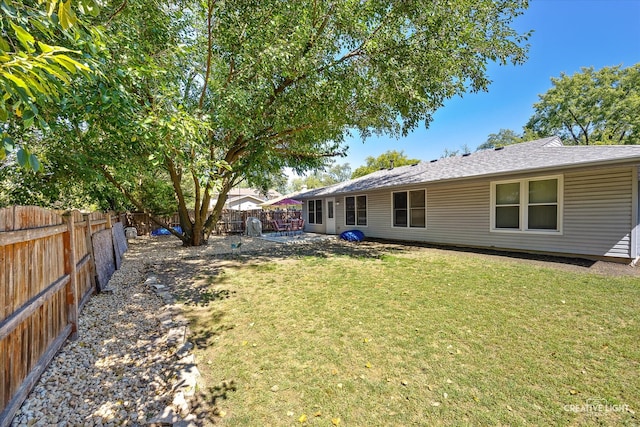 rear view of property with a lawn