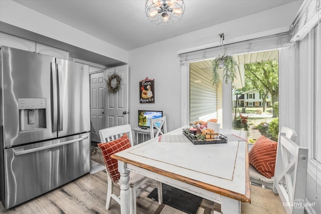 dining room with an inviting chandelier and light hardwood / wood-style floors