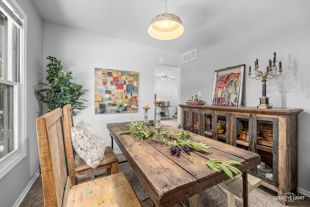 dining space featuring a healthy amount of sunlight and carpet floors