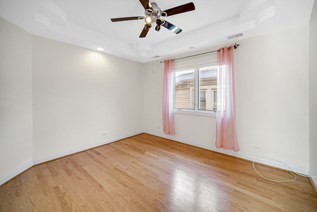 empty room with light wood-type flooring, ceiling fan, and vaulted ceiling