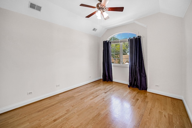 spare room featuring light hardwood / wood-style flooring, ceiling fan, and vaulted ceiling