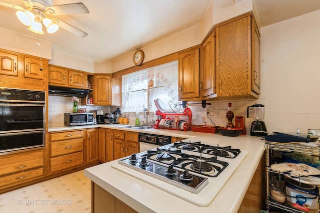 kitchen with gas cooktop, tasteful backsplash, exhaust hood, ceiling fan, and double oven