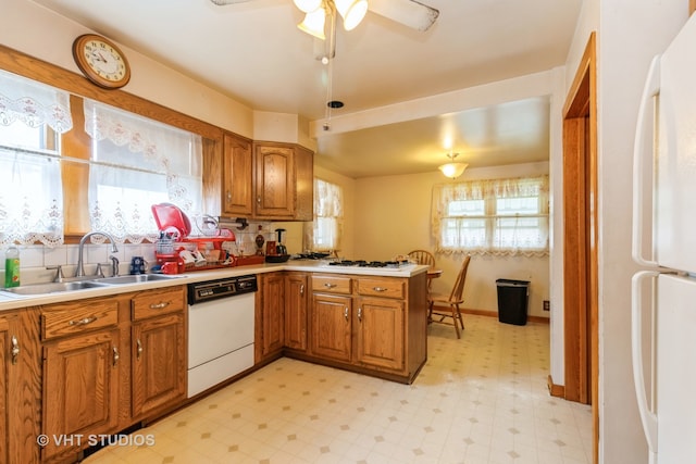 kitchen featuring ceiling fan, decorative backsplash, white appliances, sink, and light tile patterned floors