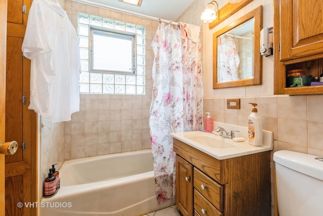 full bathroom with tasteful backsplash, toilet, vanity, tile walls, and shower / tub combo