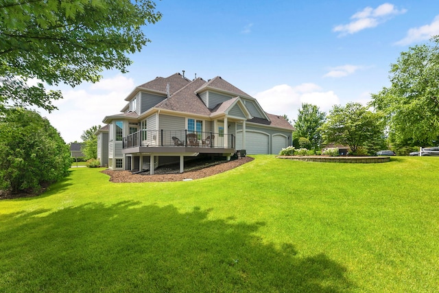 back of house with a garage, a yard, and a deck