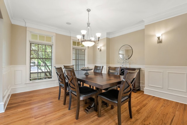 dining room featuring ornamental molding, a chandelier, and light hardwood / wood-style floors