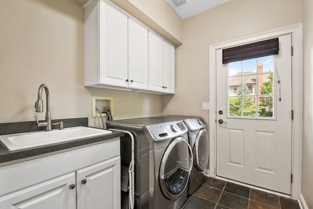 laundry room with cabinets, sink, and washing machine and clothes dryer