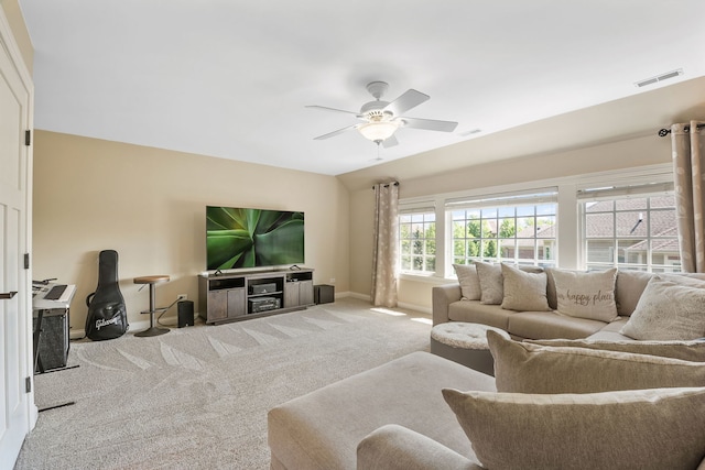 living room featuring lofted ceiling, ceiling fan, and carpet flooring