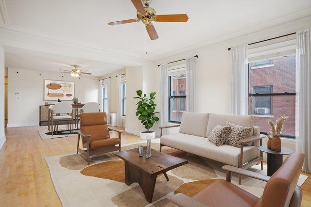 living room with ceiling fan, plenty of natural light, and light hardwood / wood-style floors