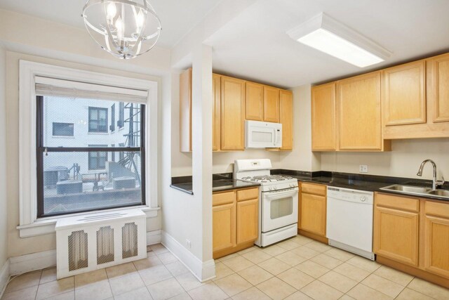 kitchen featuring pendant lighting, sink, white appliances, an inviting chandelier, and light brown cabinetry