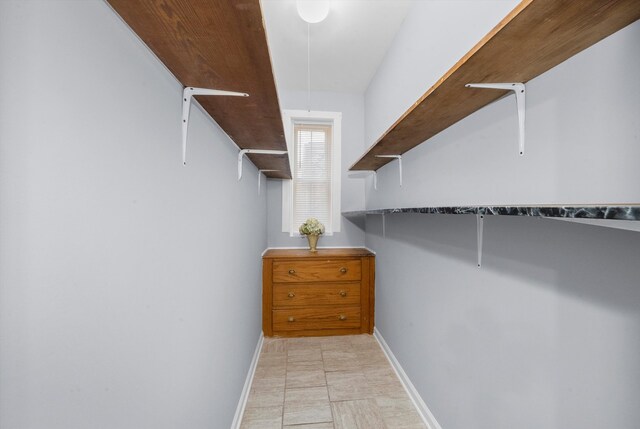 walk in closet featuring light tile patterned floors