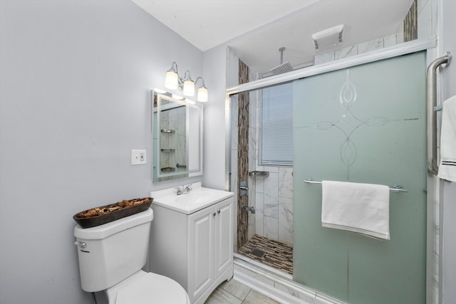 bathroom with tile patterned floors, vanity, a shower with door, and toilet