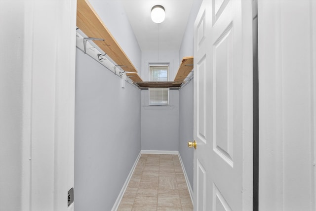 walk in closet featuring light tile patterned flooring