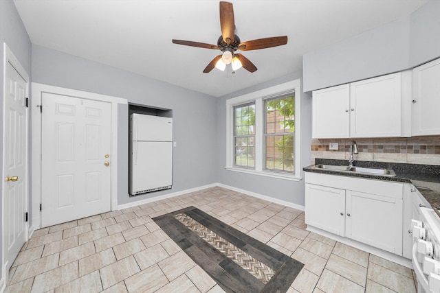 kitchen with white fridge, tasteful backsplash, light tile patterned floors, ceiling fan, and sink