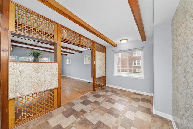 interior space featuring beamed ceiling and tile patterned floors