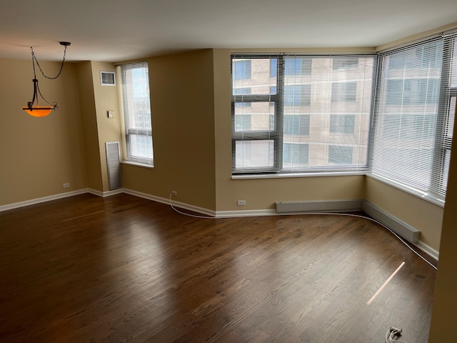 unfurnished room with dark wood-type flooring