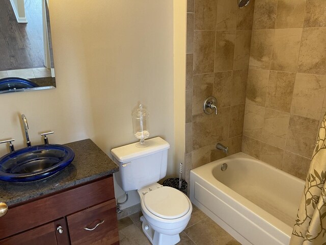 full bathroom featuring vanity, shower / bath combo with shower curtain, toilet, and tile patterned floors