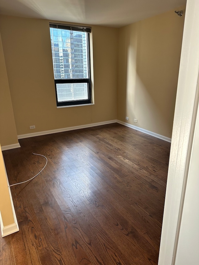 empty room featuring dark wood-type flooring