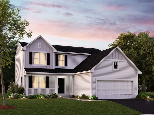 view of front facade featuring a garage and a yard