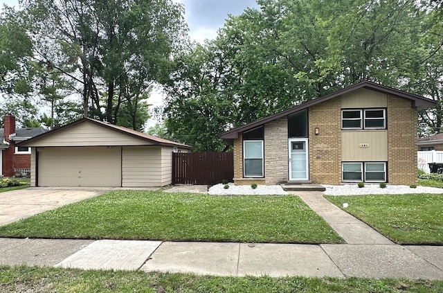 view of front of house featuring an outbuilding, a garage, and a front lawn