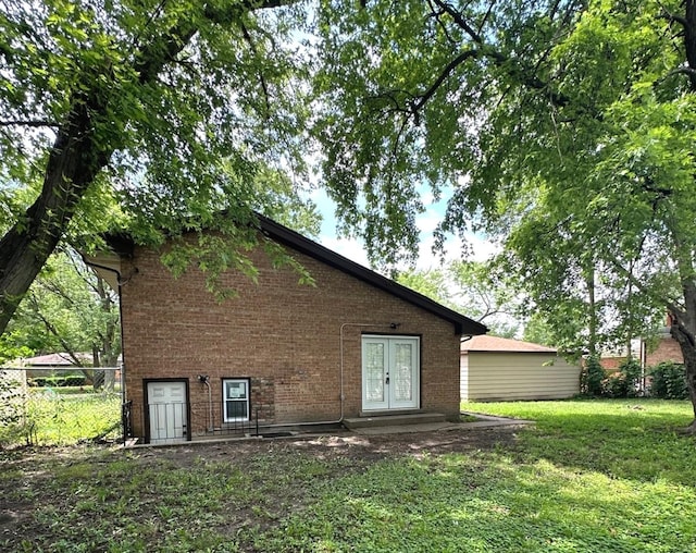 rear view of house with a yard