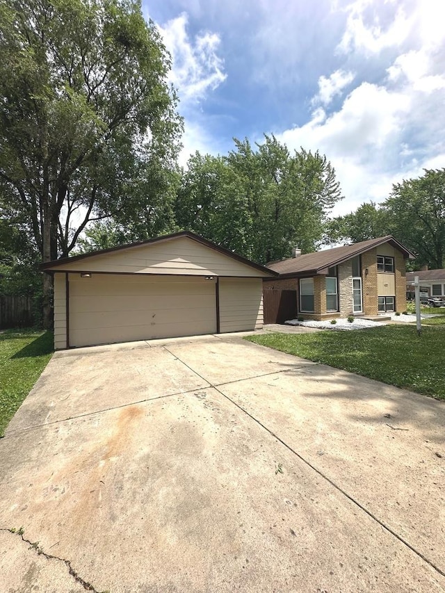 single story home featuring a front lawn and a garage