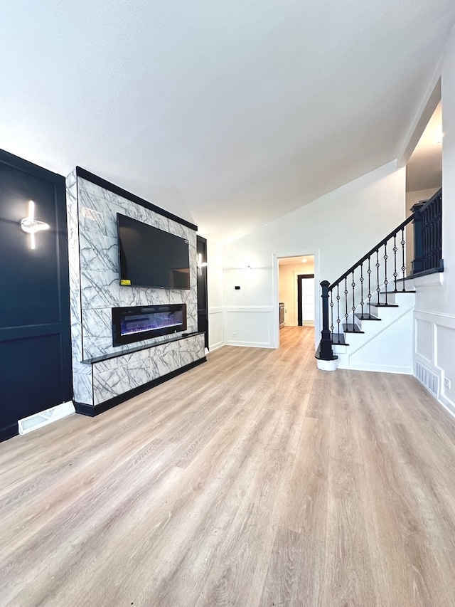 unfurnished living room featuring a fireplace and hardwood / wood-style floors