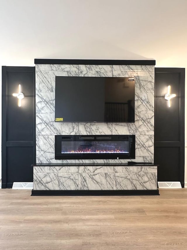 details with wood-type flooring and a premium fireplace