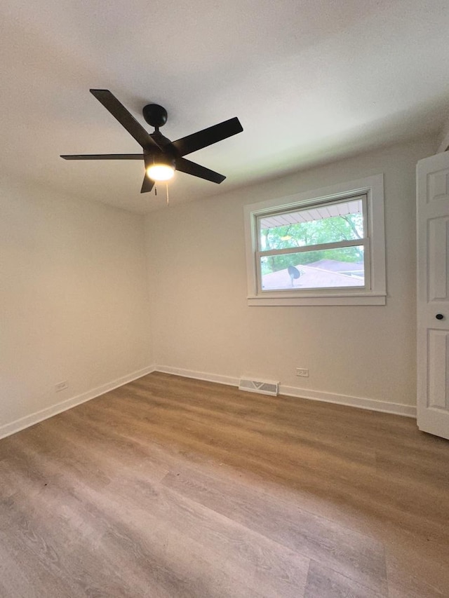 spare room with hardwood / wood-style flooring and ceiling fan