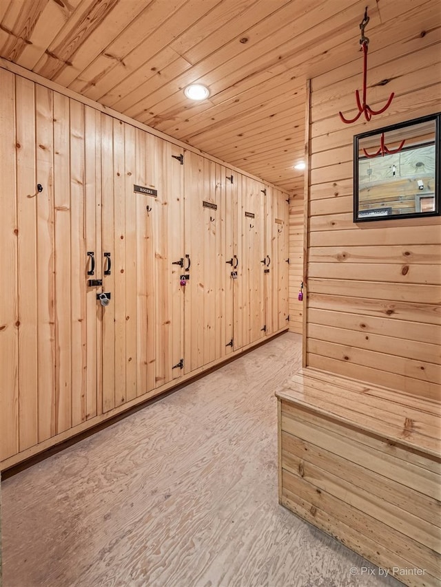 interior space with wood walls, wooden ceiling, and hardwood / wood-style flooring