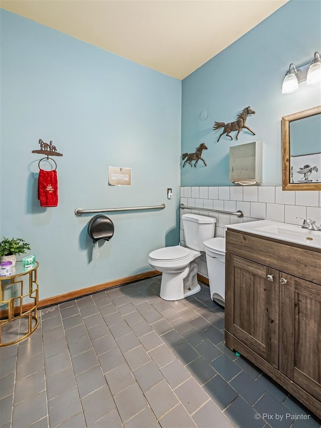 bathroom with vanity, tile patterned floors, tile walls, toilet, and backsplash