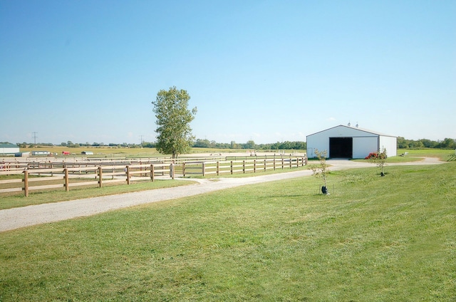 view of yard featuring a rural view and an outdoor structure