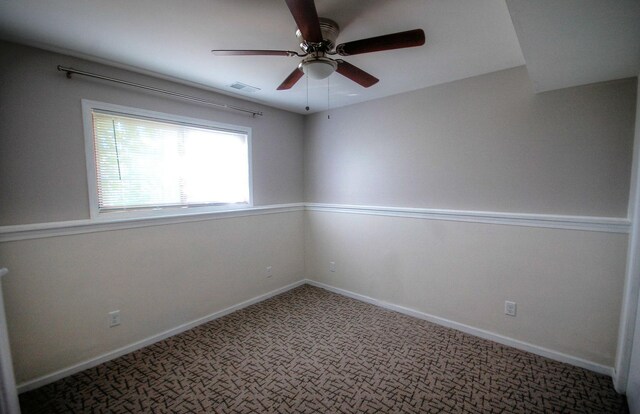 empty room featuring carpet floors and ceiling fan