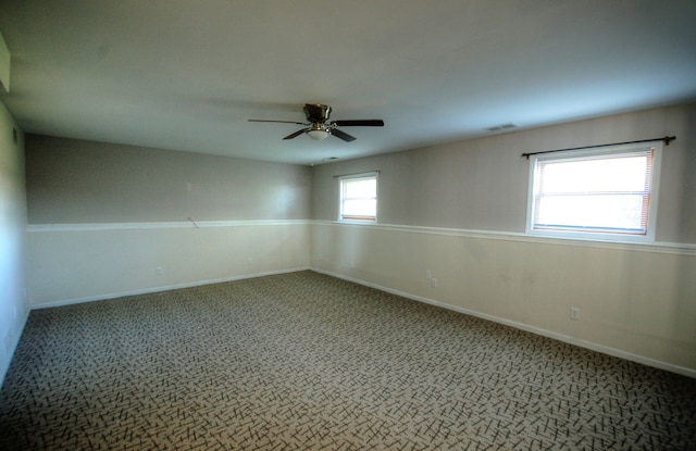 spare room featuring carpet and ceiling fan