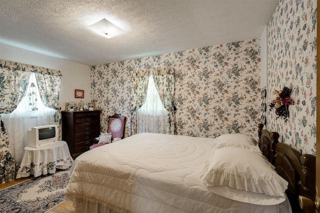 bedroom featuring hardwood / wood-style floors and a textured ceiling