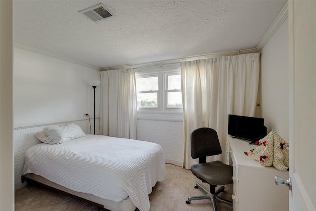 bedroom with light carpet, ornamental molding, and a textured ceiling