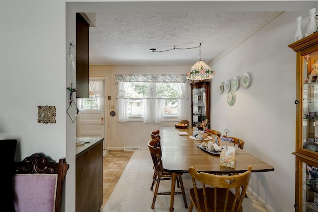 dining space featuring a textured ceiling